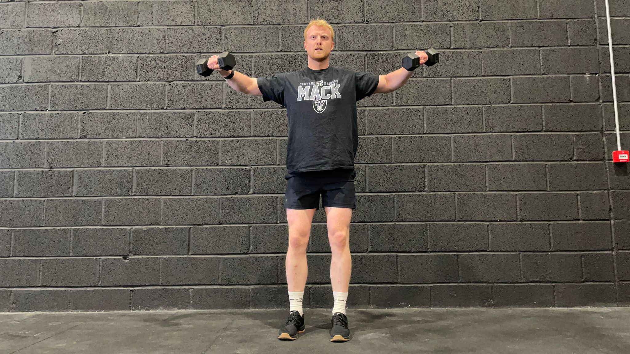 TechRadar fitness writer Harry Bullmore demonstrating a lateral raise