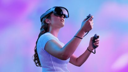 Meta Quest Pro VR headset being worn by a woman in a white short sleeve