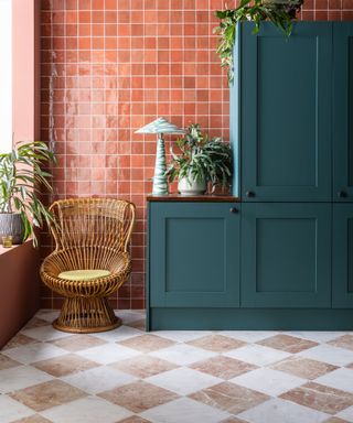 pink and white tiles, green cabinetry, rattan chair, sculptural table lamp, orange, terracotta style wall tiles