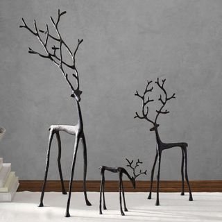 Bronze Sculpted Reindeer against a gray background.