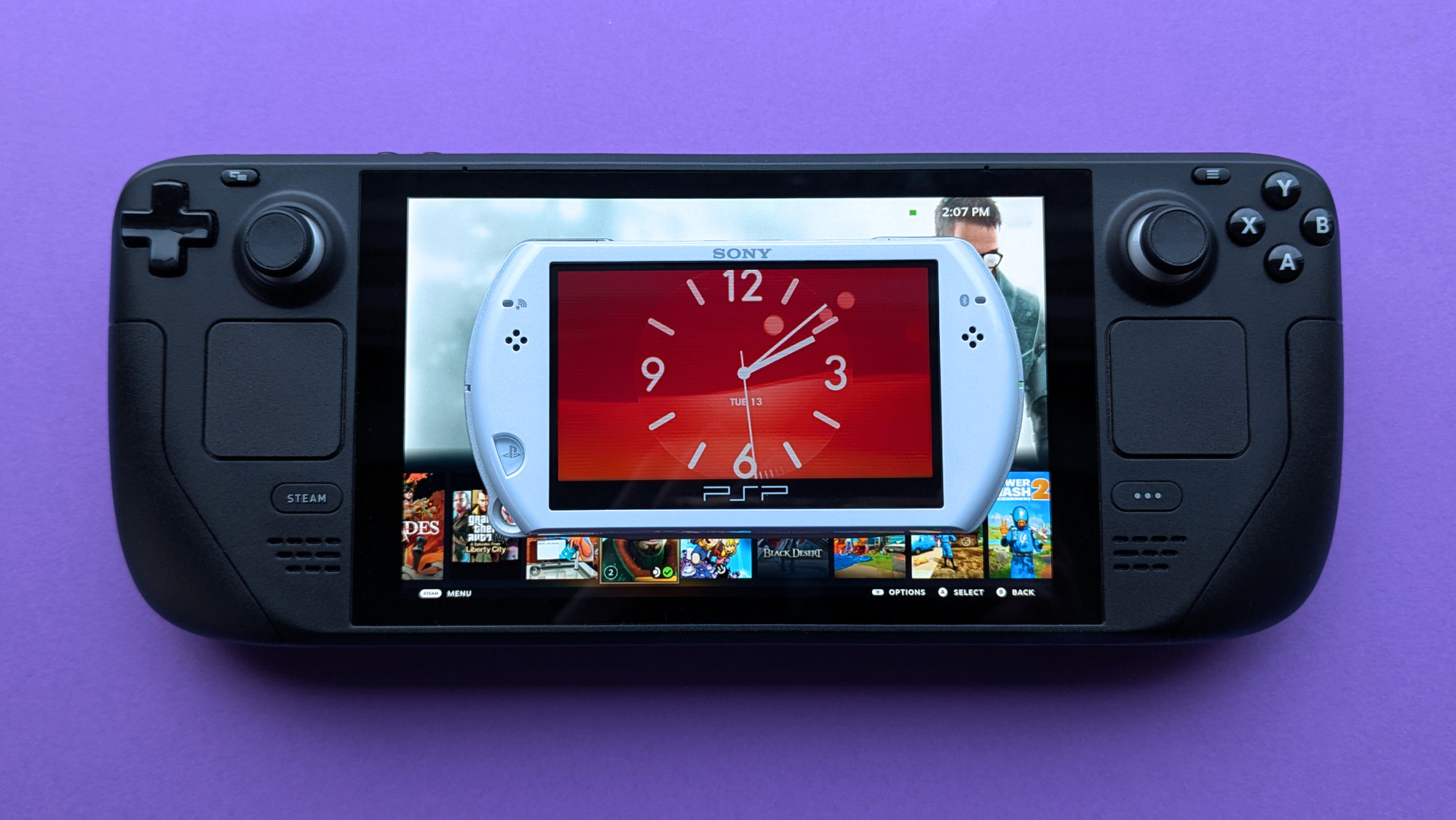 Sony PSP Go handheld resting above a Steam Deck on a purple card stock background