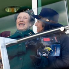 Carole Middleton hugging Princess Anne at Cheltenham races