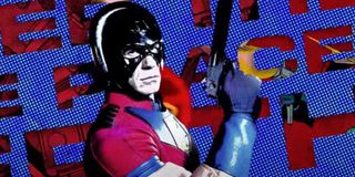 The Suicide Squad John Cena holding his gun as The Peacemaker