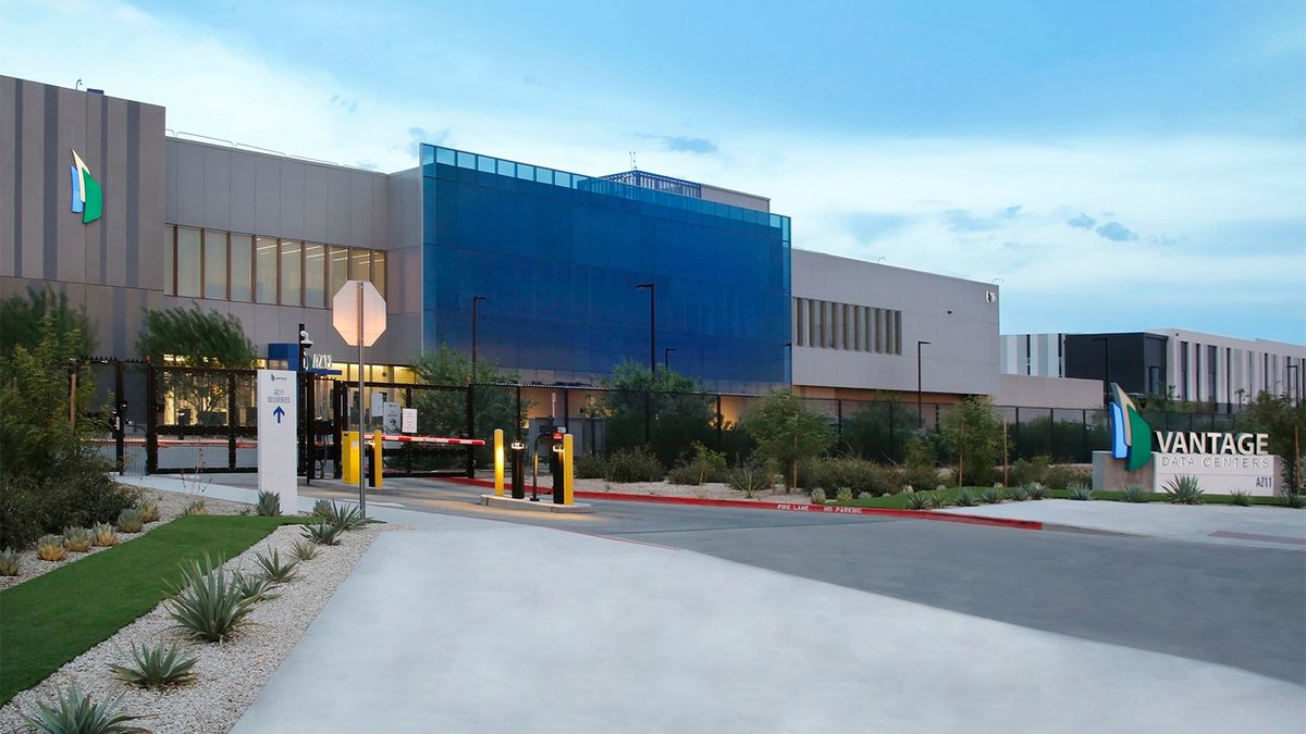 Vantage Data Centers HQ pictured at dusk with logo and branding pictured on a sign at entrance.