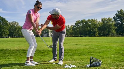 Female golfer being given instruction
