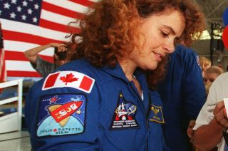 Canadian Space Agency astronaut Julie Payette, seen in 1999 after her first spaceflight, wearing her personal mission patch.
