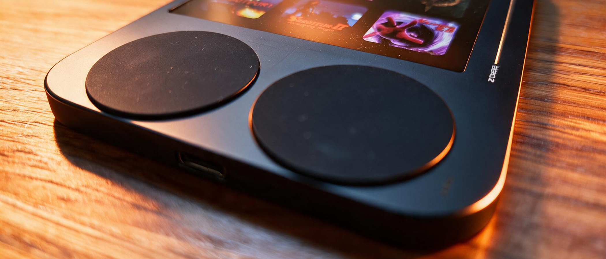 A black retro game handheld with large rubber keys