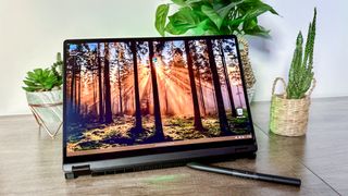 Asus ProArt PX13 with woodland desktop on screen