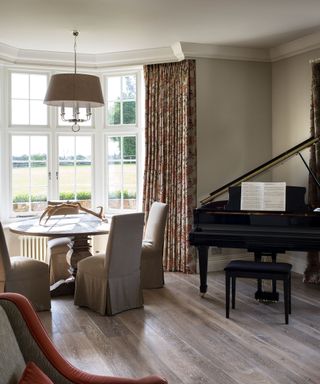 Music room with grand piano and dining table and chairs