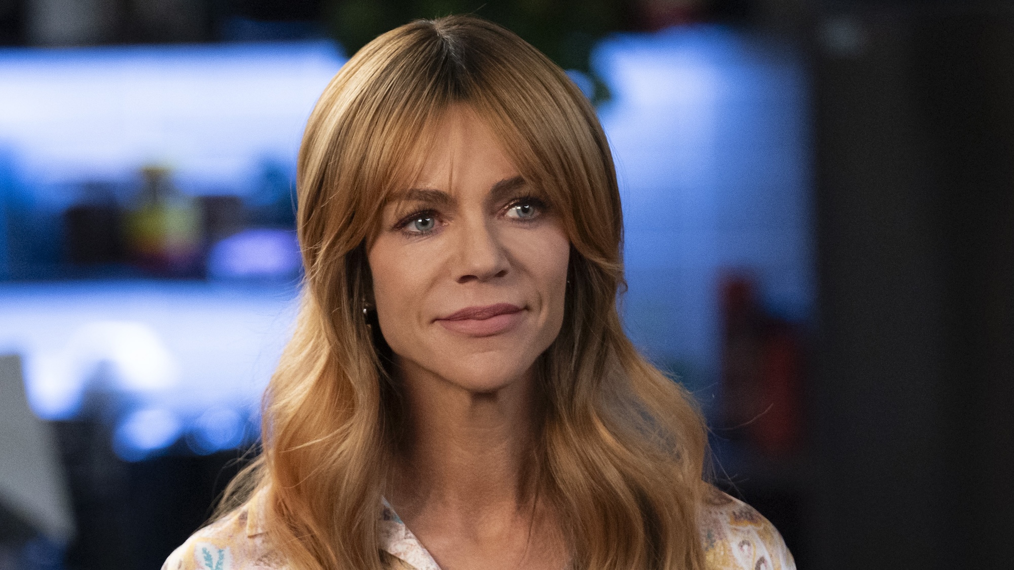 Kaitlin Olson's Morgan with her hair covering both shoulders, standing in police station in High Potential Season 2