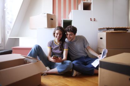 couple sitting by packing boxes