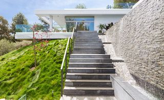 A cascading stone staircase leads visitors to the house, highlighting 'a sense of arrival'