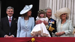 King Charles and Queen Camilla with her granddaughter on the balcony of Buckingham Palace