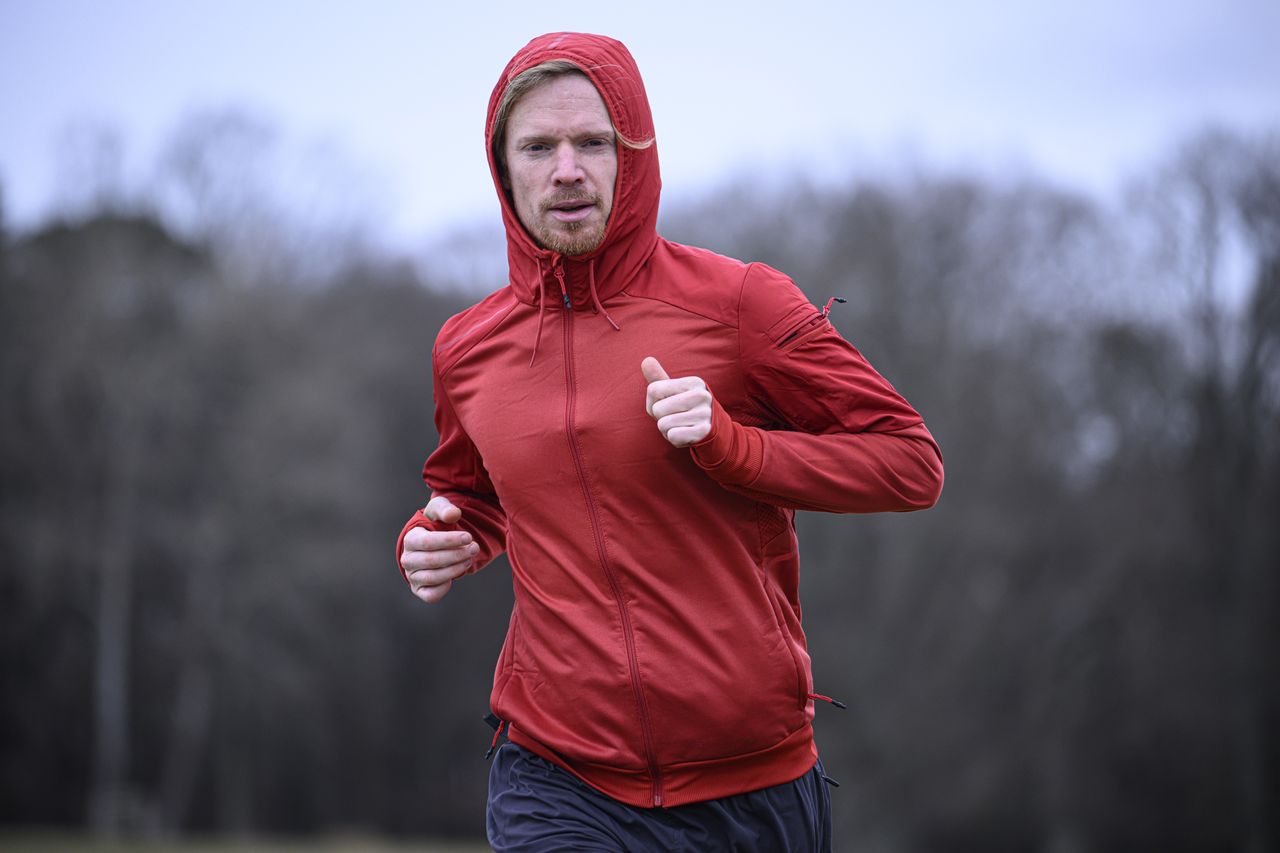 A man in a red jacket running