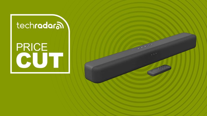 Amazon Fire TV Soundbar on green background with TechRadar price cut sign