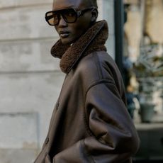 Woman wears oversized sunglasses, brown borg and faux suede coat