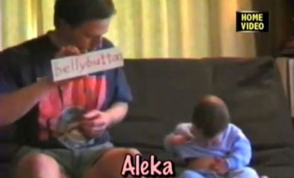 Nine-month-old Aleka points to her bellybutton after her father shows her a "Your Baby Can Read" flashcard of the word: But is she, in any true sense, reading it?