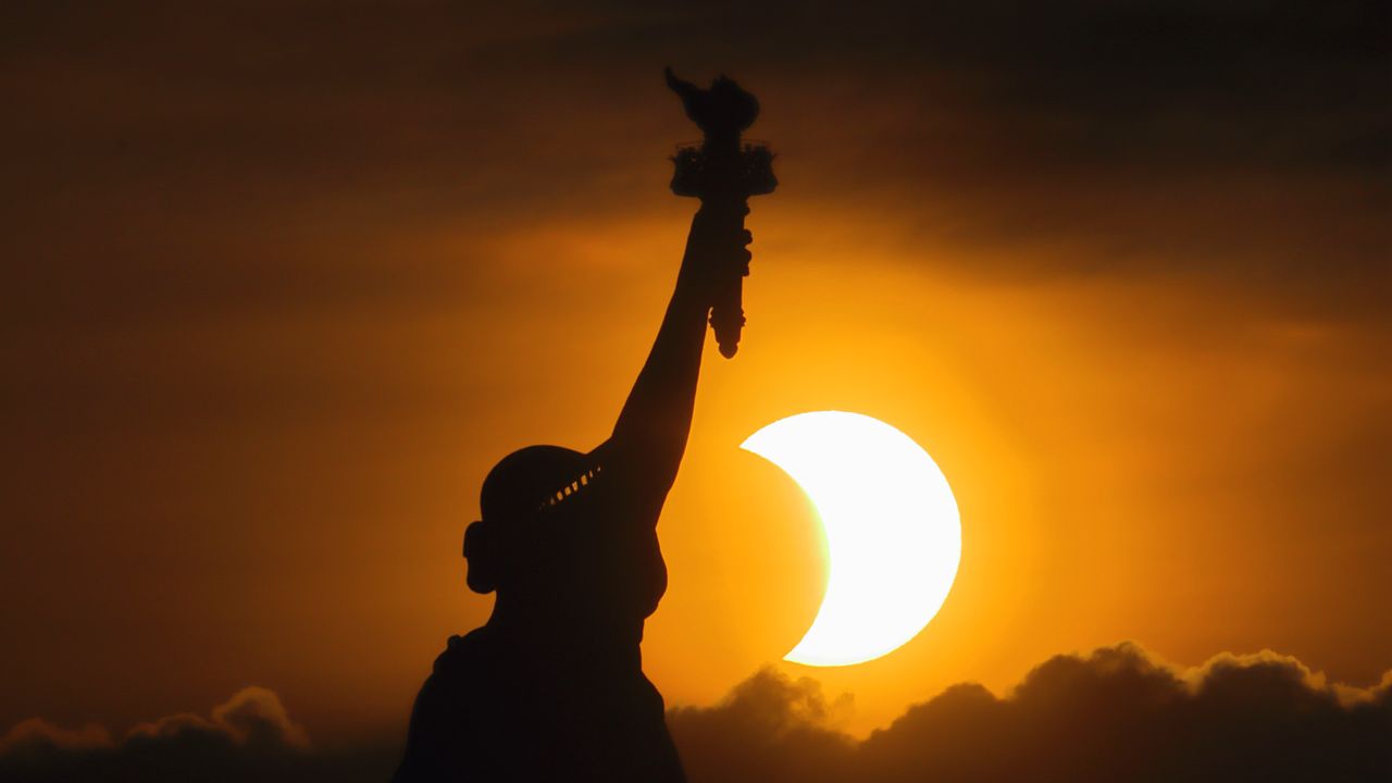 The Statue of Liberty and the partial solar eclipse of June 10, 2021, as photographed by Gary Hershorn.