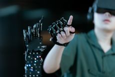 Man pointing at robot arm