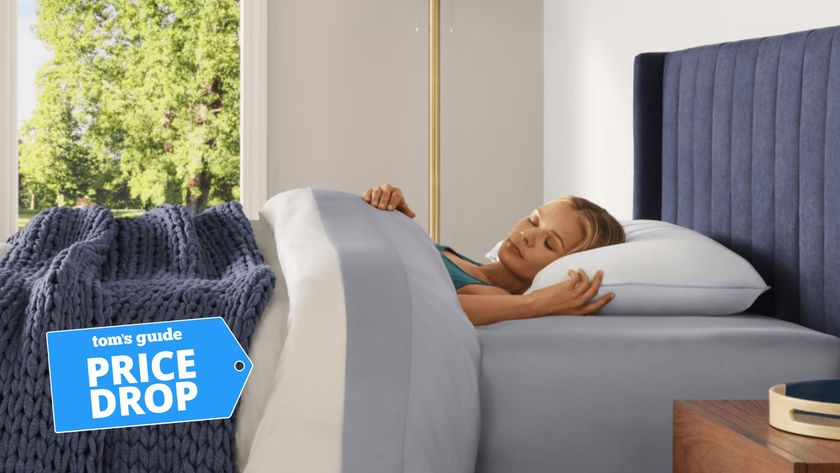 A woman sleeping in bed with Tempur-Pedic cooling mattress, sheet set and pillow 