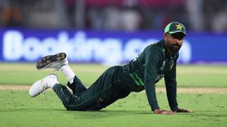 Babar Azam of Pakistan flops down onto the grass ahead of the Pakistan vs Bangladesh ICC Men's Cricket World Cup clash.