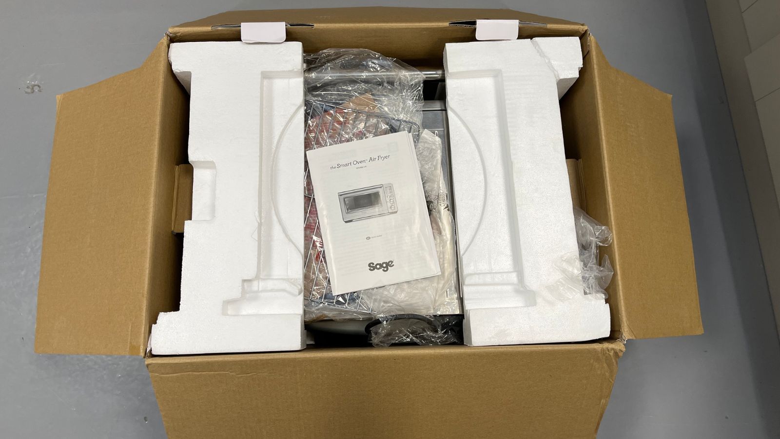 The Breville the Smart Oven Air Fryer Toaster Oven in its cardboard box and packaging