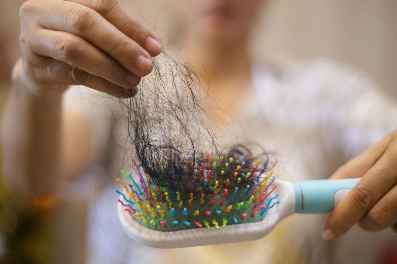 A and puling hair out of a hairbrush