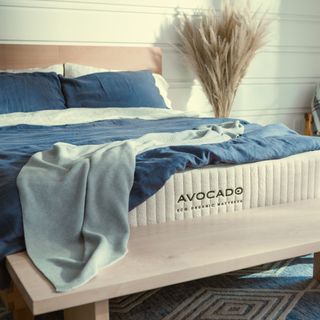 Avocado Eco Organic Mattress on bed with blue bedding