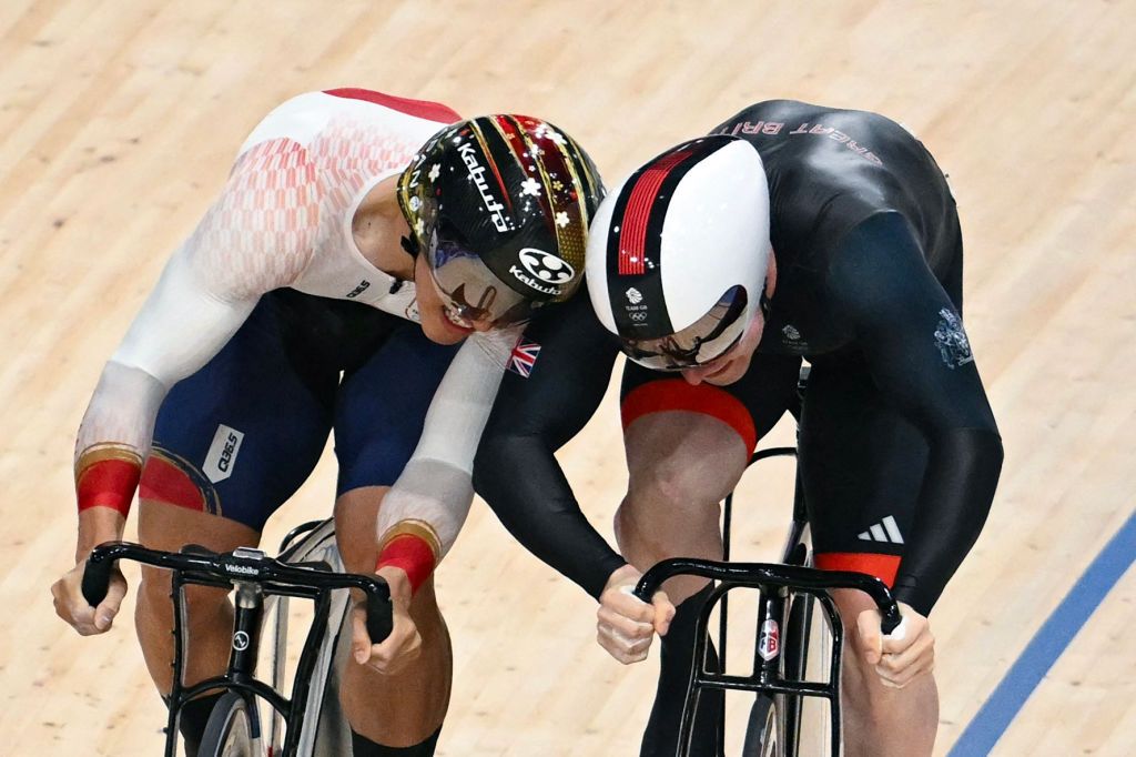 Britain's Jack Carlin and Japan's Kaiya Ota make contact as they compete in the men's track cycling sprint quarter-final race 2 of the Paris 2024 Olympic Games at the Saint-Quentin-en-Yvelines National Velodrome in Montigny-le-Bretonneux, south-west of Paris, on August 8, 2024. (Photo by SEBASTIEN BOZON / AFP) / &acirc;The erroneous mention[s] appearing in the metadata of this photo by SEBASTIEN BOZON has been modified in AFP systems in the following manner: [Japan's Kaiya Ohta] instead of [Japan's Riyu Ohta]. Please immediately remove the erroneous mention[s] from all your online services and delete it (them) from your servers. If you have been authorized by AFP to distribute it (them) to third parties, please ensure that the same actions are carried out by them. Failure to promptly comply with these instructions will entail liability on your part for any continued or post notification usage. Therefore we thank you very much for all your attention and prompt action. We are sorry for the inconvenience this notification may cause and remain at your disposal for any further information you may require.&acirc;