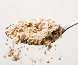 Oatmeal being sprinkled from a spoon