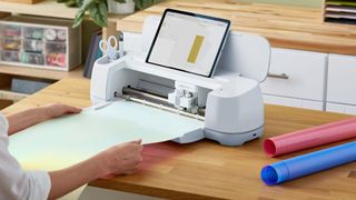 Reasons to get cricut access: a photo of someone using a Cricut Maker