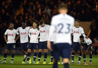 Tottenham's players wait as Christian Eriksen walks back after missing his penalty