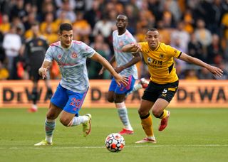 Manchester United’s Diogo Dalot (left) and Wolverhampton Wanderers’ Marcal battle for the ball during the Premier League match at Molineux Stadium, Wolverhampton. Picture date: Sunday August 29, 2021