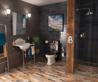 bathroom with brick effect floor tiles, dark walls and wooden column