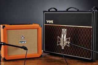 Small Orange amp next to larger Vox amp