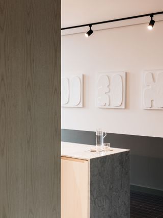 Kitchen area at Oper46 featuring white wall art and bar of black spotlights