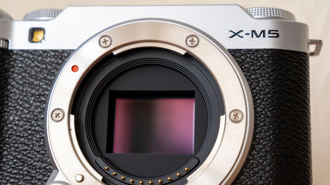 A close-up of the Fujifilm X-M5 with a maroon sensor
