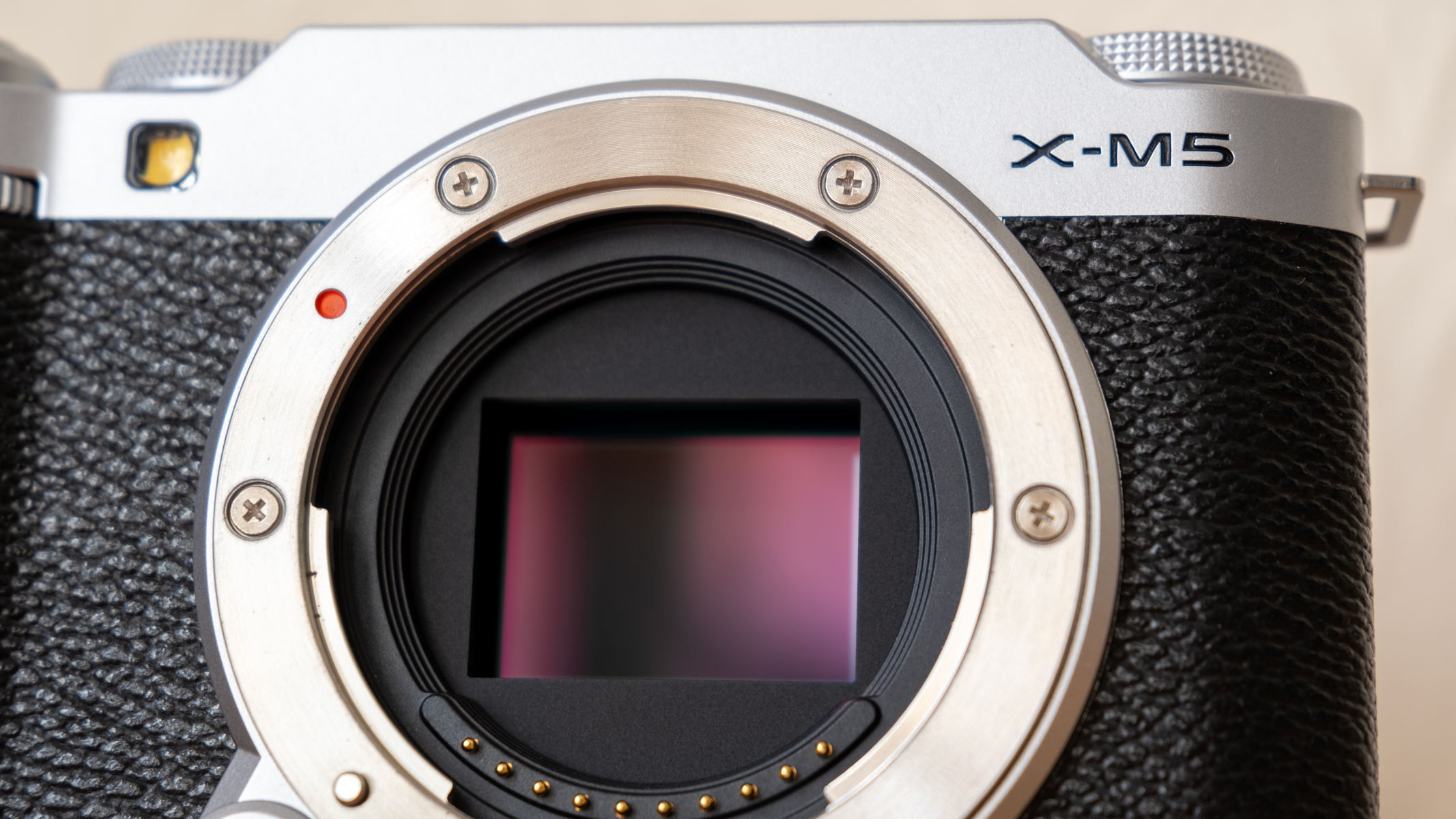 A close-up of the Fujifilm X-M5 with a maroon sensor