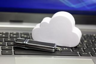 Cloud sitting on laptop with memory stick