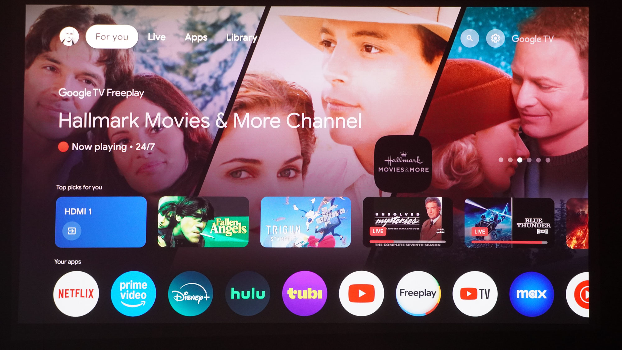 The projection from a JMGO N1S Ultimate projector displaying Google TV Freeplay.