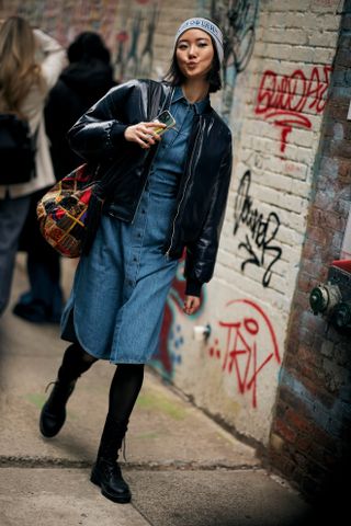 Woman wearing denim dress & combat boots