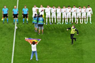 A protestor demonstrates in front of the Hungarian team during their Euro 2020 clash with Germany