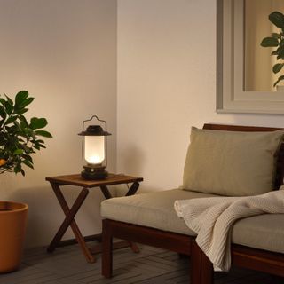 Portable light on a modern table makes useful backyard lighting option