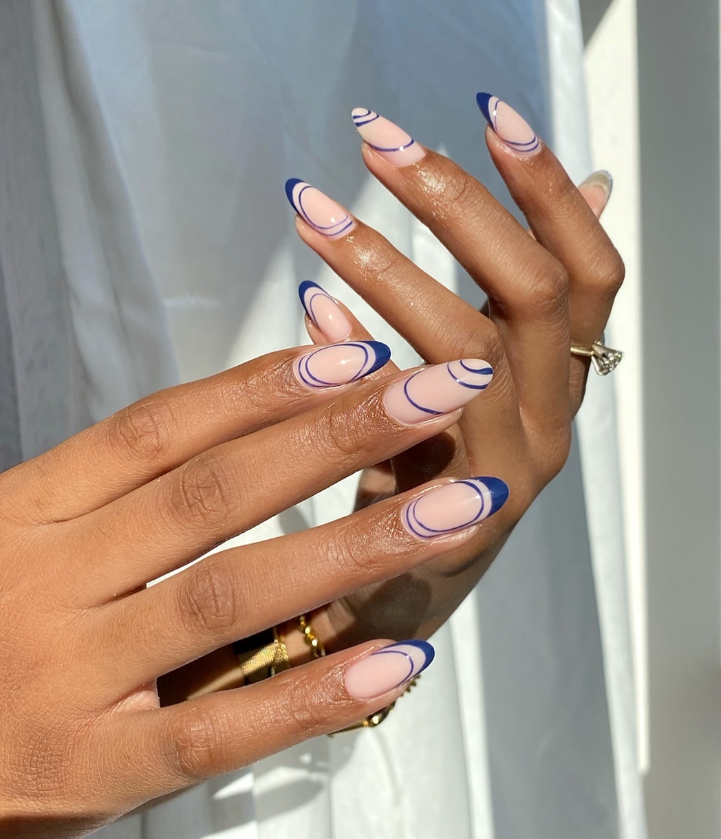 navy blue and sheer pink manicure with geometric designs