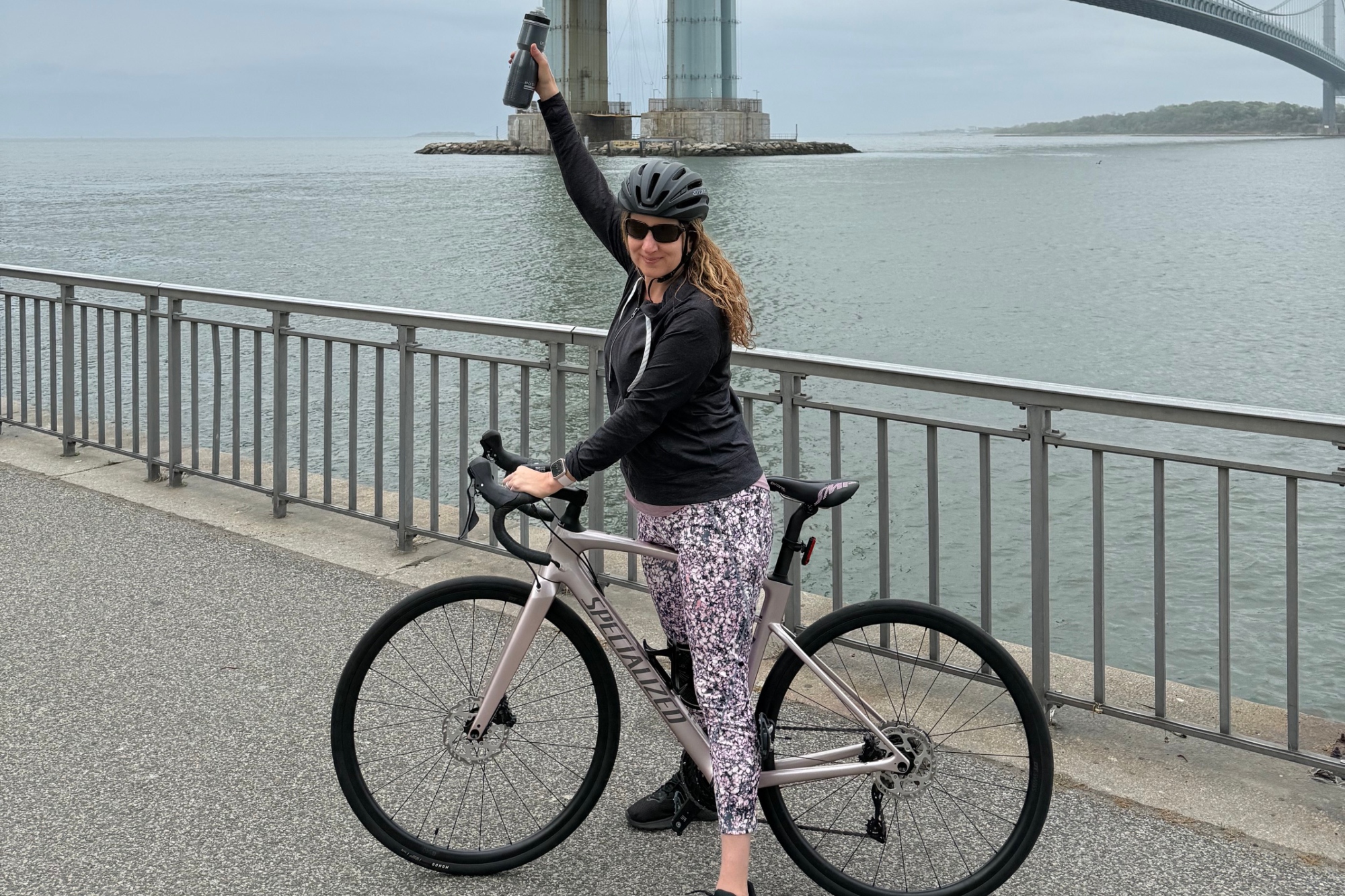 Patricia Hochhauser stands over her bike triumphant 