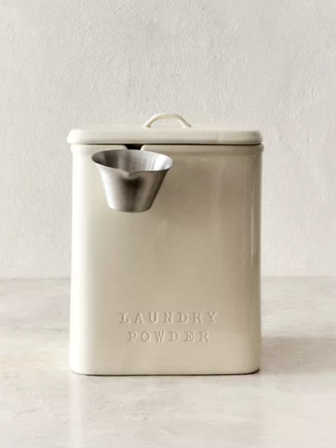 A white laundry powder tin with a ladle from Zara Home