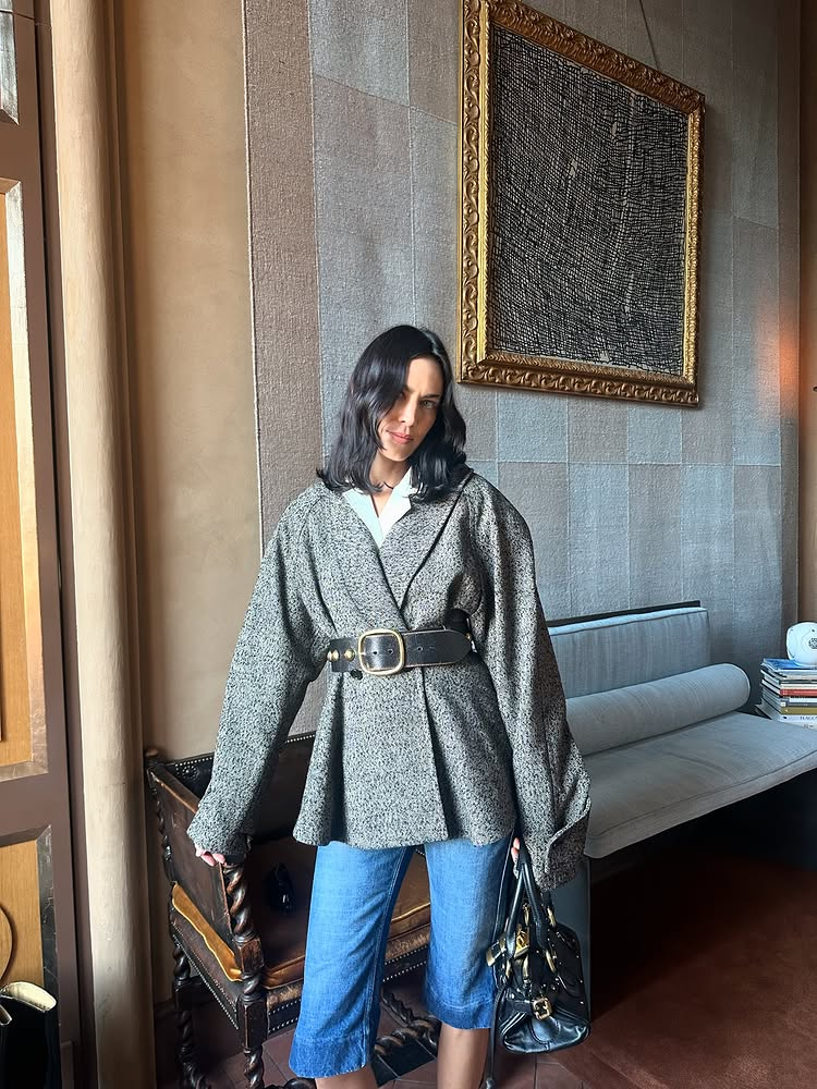 Alexa Chung wears Chloe denim capri pants with a grey wrap jacket and a chunky belt.