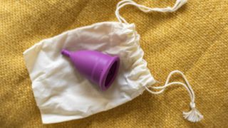 A purple menstrual cup