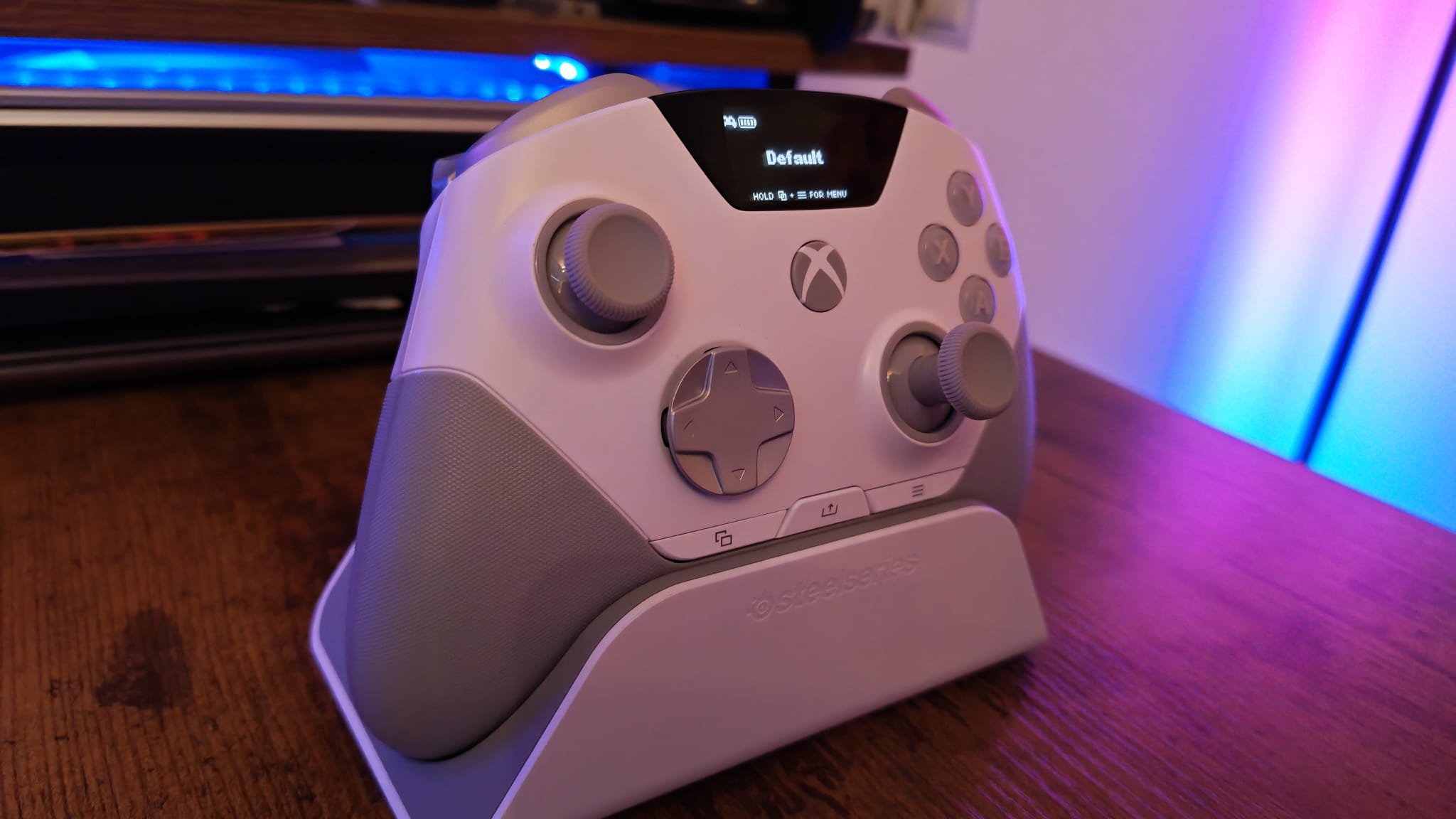 A SteelSeries Aeon Pro controller on its charging stand