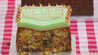 A soggy fruit cake holds a badly iced tennis court
